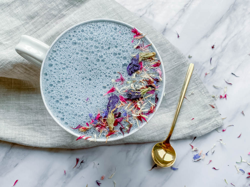 Ayurvedic sleep tonic in a white mug with gold spoon.