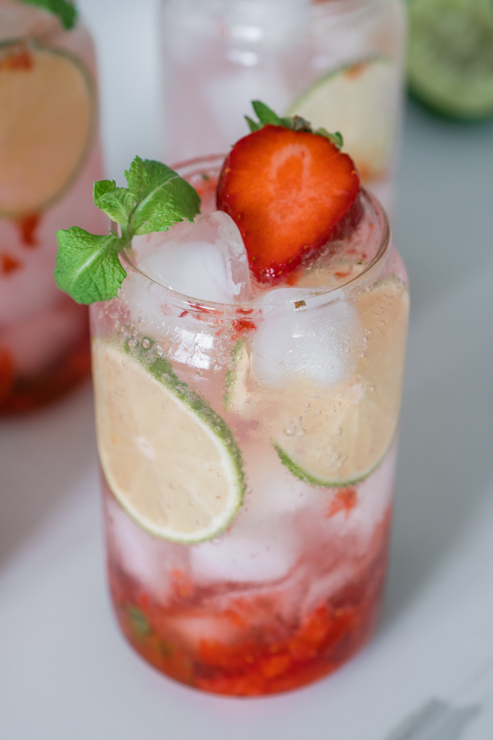 Strawberry Mojito Mocktail in a short glass filled with ice.