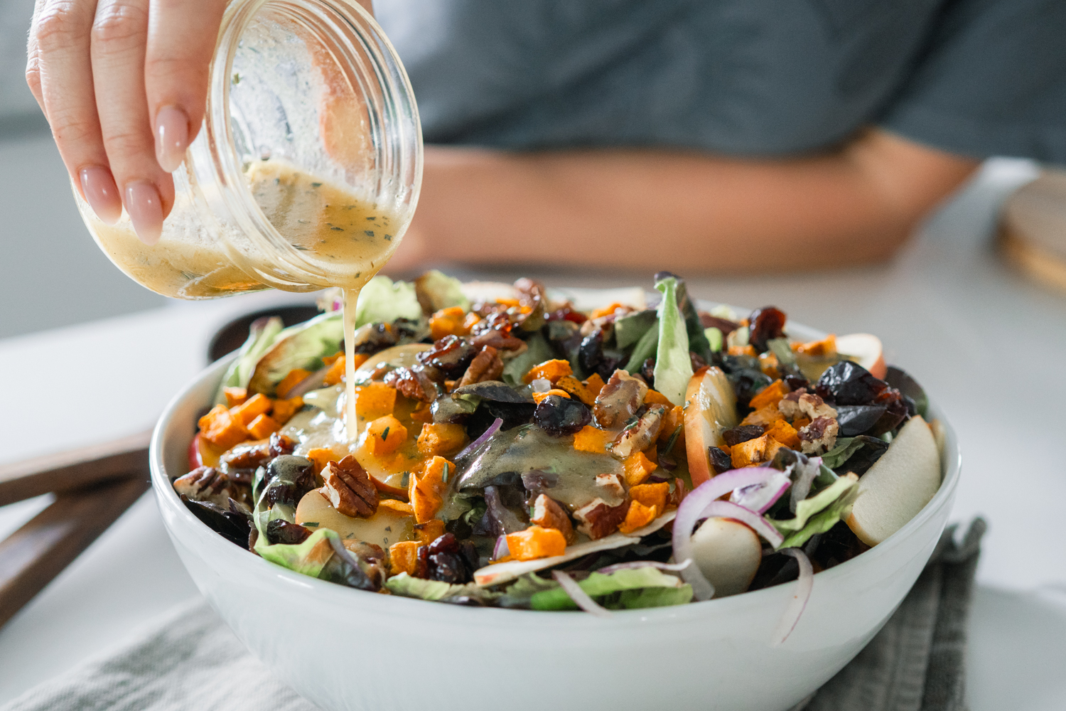 Apple Harvest Salad with cranberries, apples, pecans, red onion and drizzled with a rosemary vinaigrette.