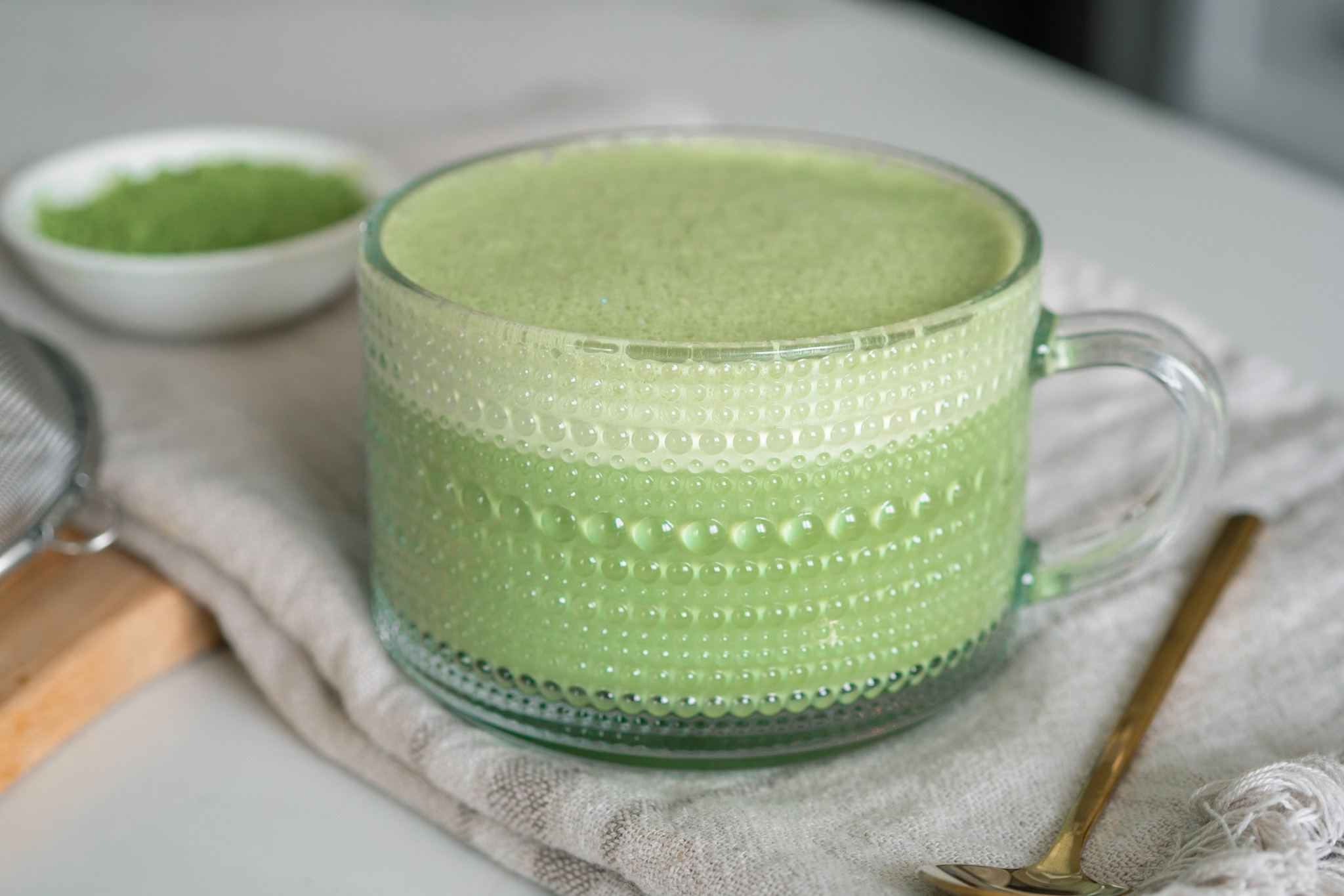 classic matcha latte in a clear glass