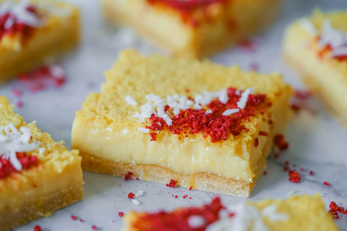 Tart lemon square sprinkled with coconut flakes and freeze dried raspberries.