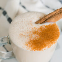 Vanilla chai tea latte with dairy-free milk in a clear glass mug.
