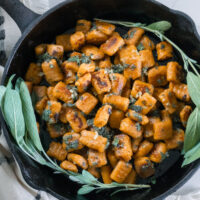 Sweet potato cassava gnocchi in a cast iron pan with fresh sage.