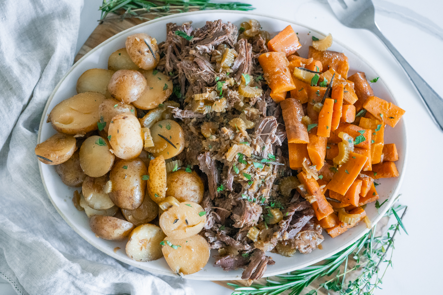 Slow cooker roast beef with carrots and potatoes.