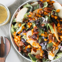 Apple Harvest Salad with cranberries, apples, pecans, red onion and drizzled with a rosemary vinaigrette.