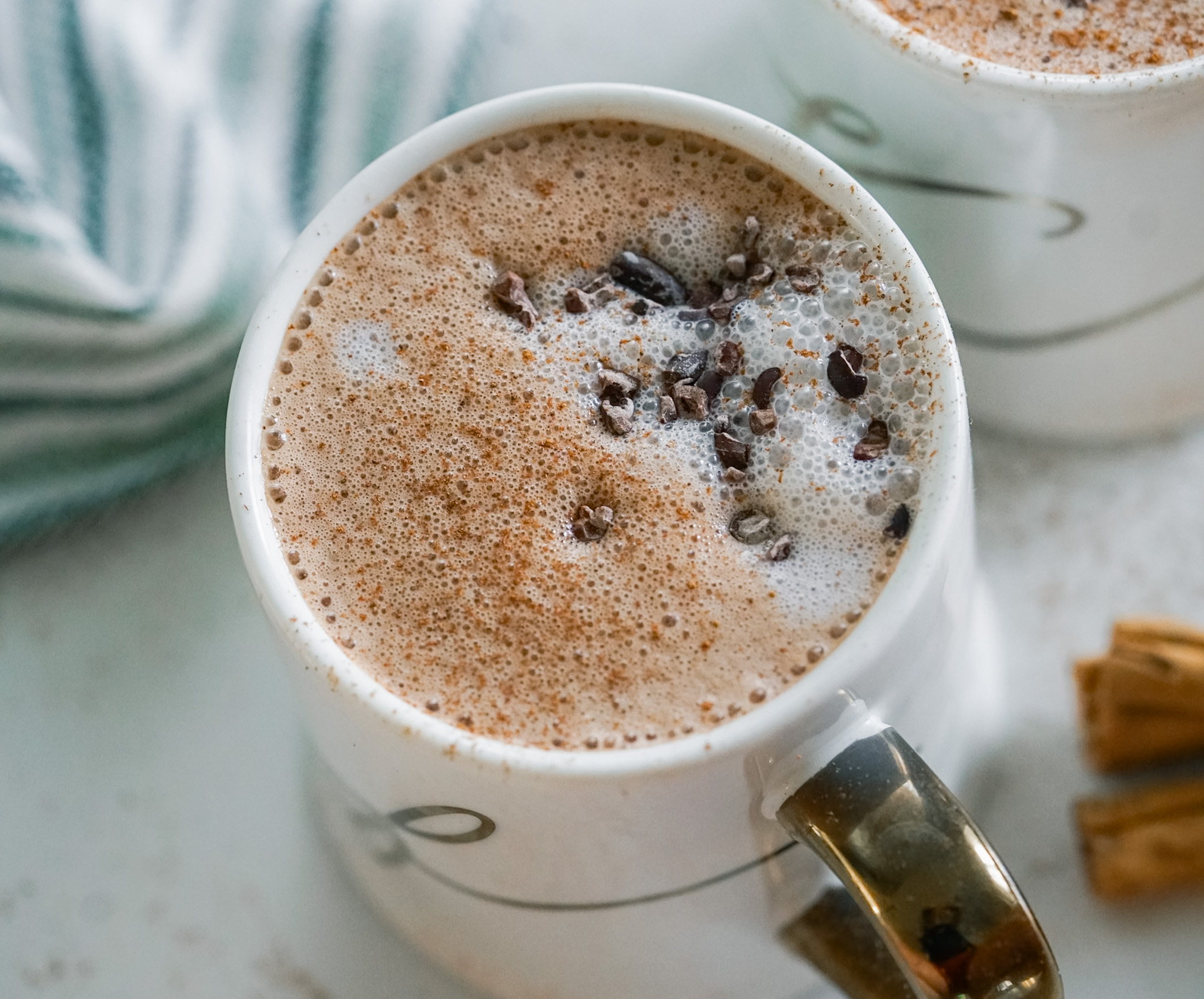 Acne Friendly Latte in a white and gold cup.